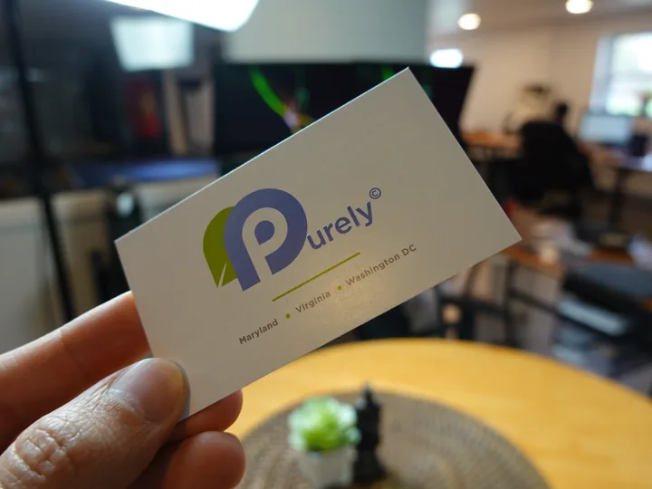 Dull matte finish business cards resting on a colored surface