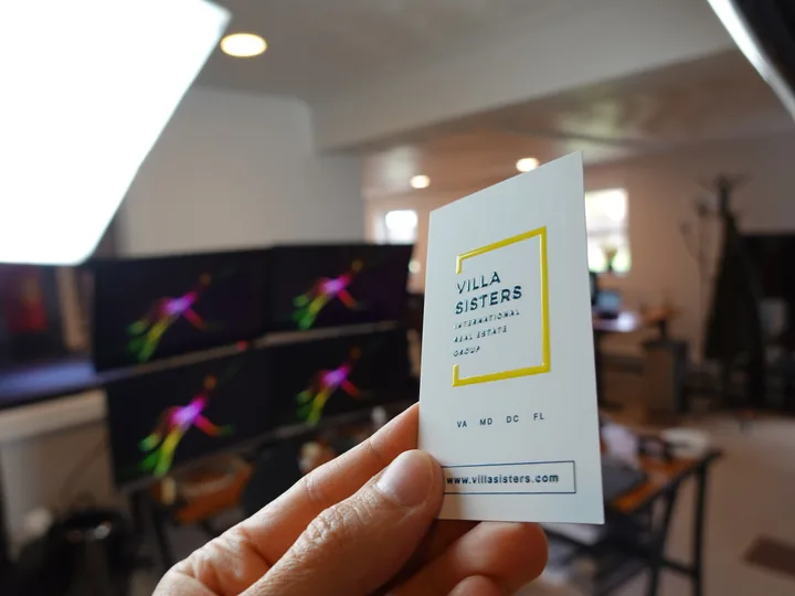 Premium finished business cards on a dark slate surface