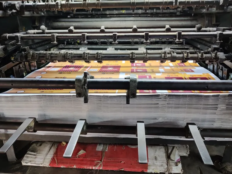 Color sheets running through an offset printing press