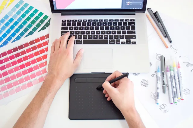 Designer matching brand colors on a print proof before production